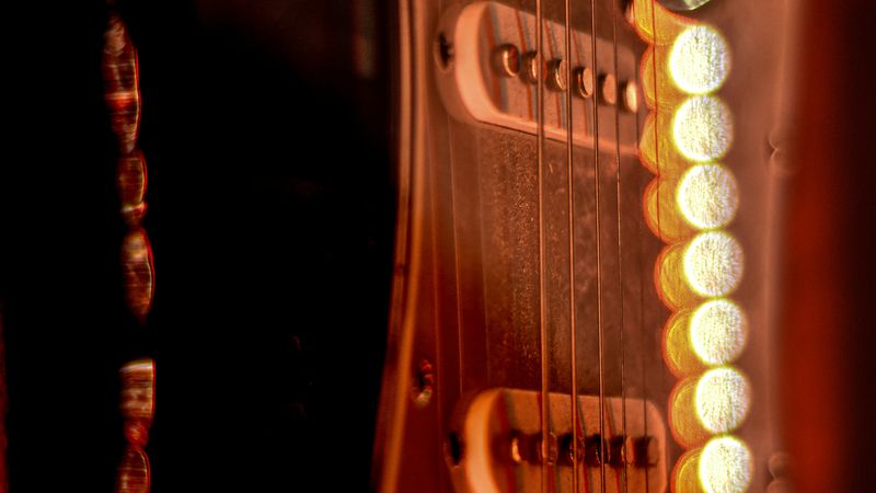 Close-up of electric guitar strings and pickups